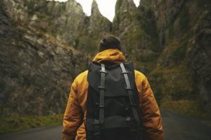 man in yellow jacket hiking